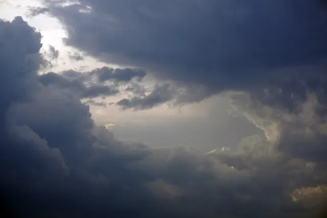 A storm front building over rooftops